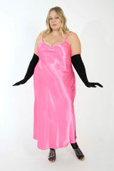 Full-length studio shot of a blonde plus-size model wearing the bright pink Best Curve bamboo slip dress styled with long black opera gloves.