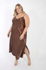 Front view of a plus-size model posing in the silky chocolate brown bamboo maxi slip dress with adjustable spaghetti straps.