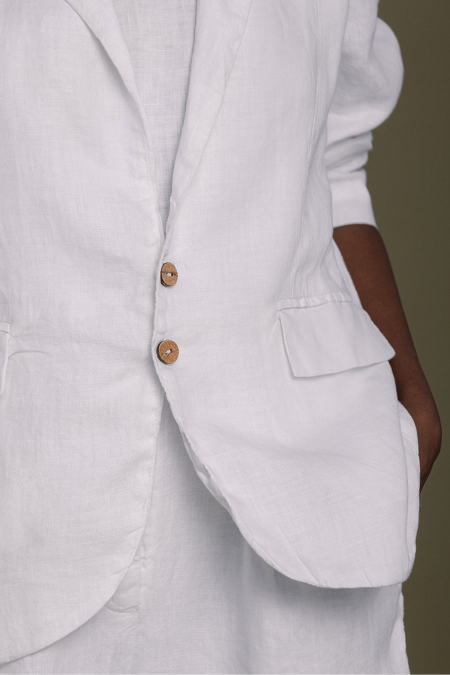 Detailed close-up of the Reistor She's Everything Blazer in White, focusing on the texture of the eco-friendly 100% hemp fabric, front flap pocket, and two sustainable round buttons.