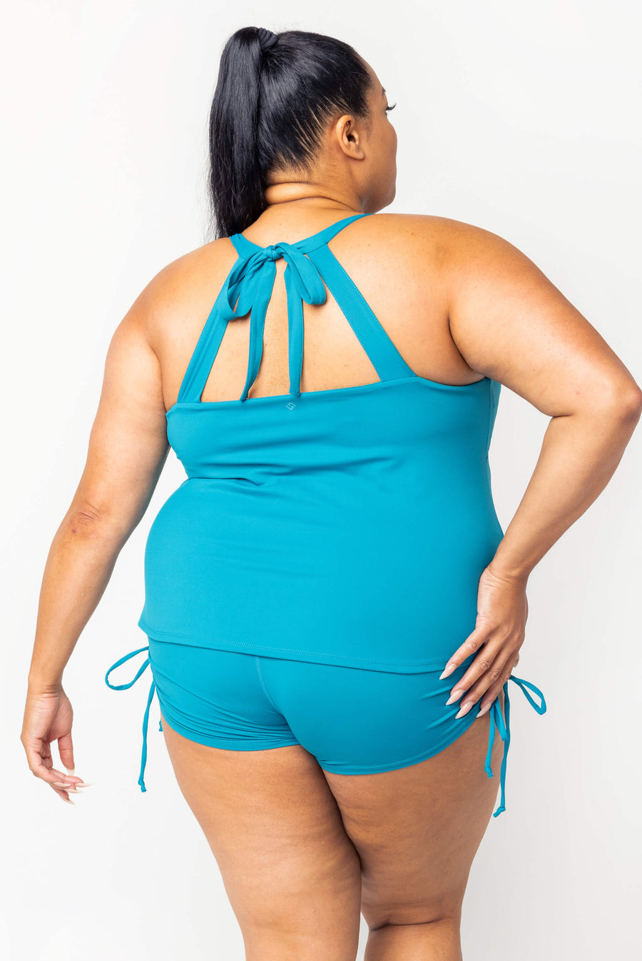 Rear view showing the cross-tie back design and supportive straps of the teal Superfit Hero Tankini Swim Top.