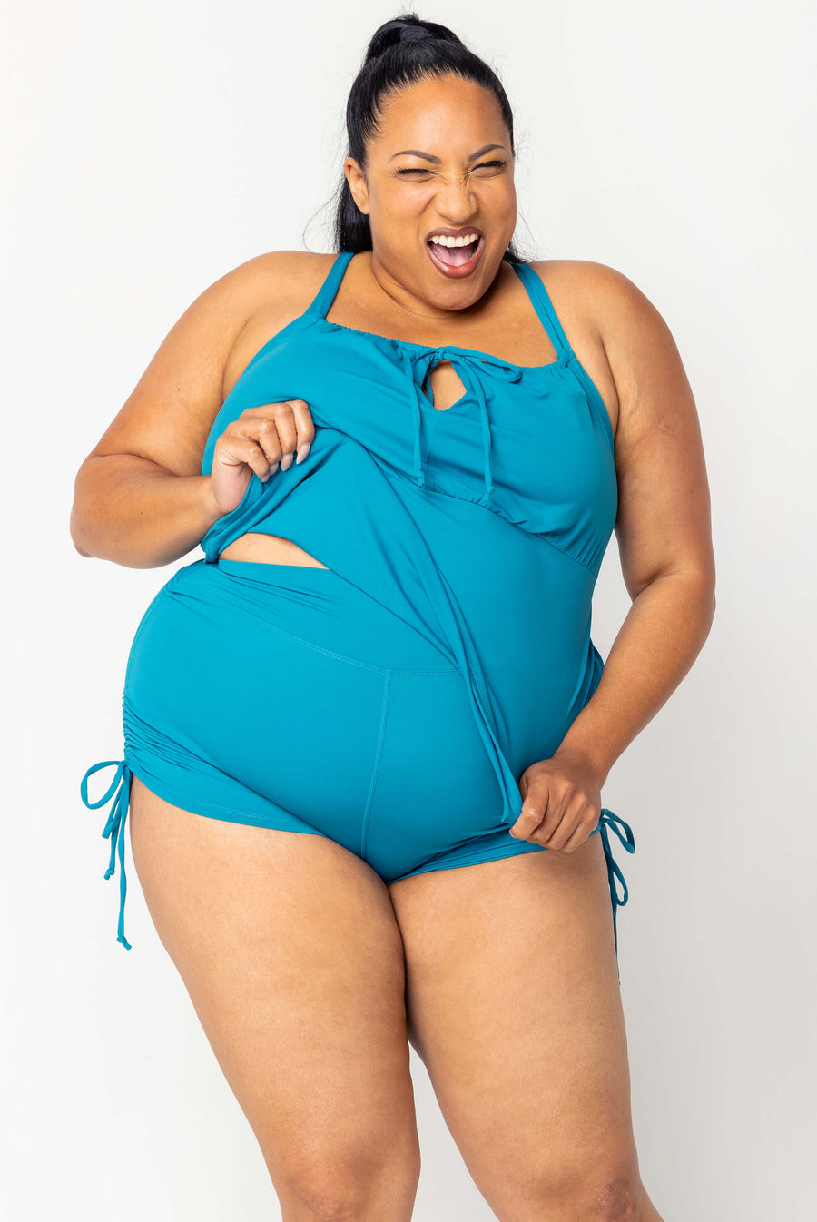 Detailed angle showcasing the smooth Sweat/Swim fabric and front cinch string on the teal Superfit Hero tankini.