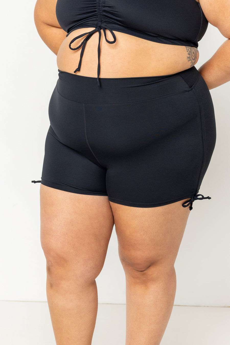 Front view close-up of high-waisted black Superfit Hero Swim Booty Shorts highlighting the smooth, curve-hugging compression fit.