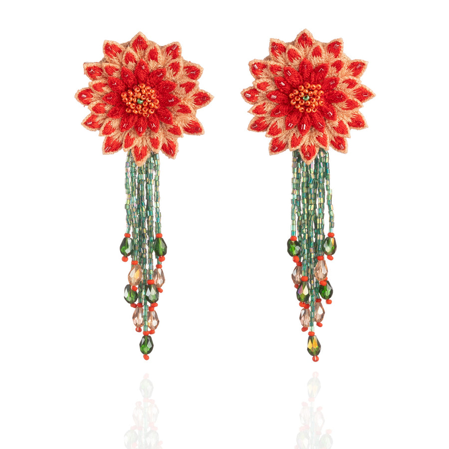 Front view of the Fyoli Fyoli DAHLIA Embroidered Earrings in Coral Red on a white background. The intricate 3D flower design features hand-embroidered petals and a long, flowing iridescent green glass bead fringe.