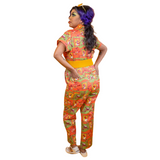 Rear view of a model wearing the Blue Platypus Brownstone Betties Jumpsuit showing the back pockets and tailored fit.