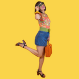 Dynamic studio pose of model kicking up her leg while showcasing the Blue Platypus Brownstone Betties Tulip Sleeve Tee in Pumpkin & Olive.