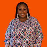 Plus-size model smiling while wearing the size-inclusive Blue Platypus Fruit Picnic Pullover in Blueberry.