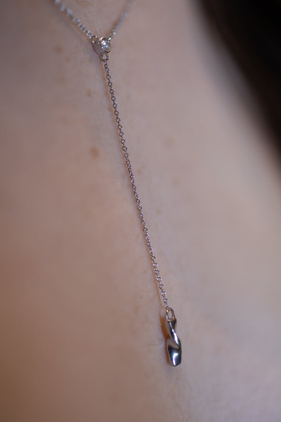 Chouette Designs a close up of the diamond and drop of the Alsace necklace in silver