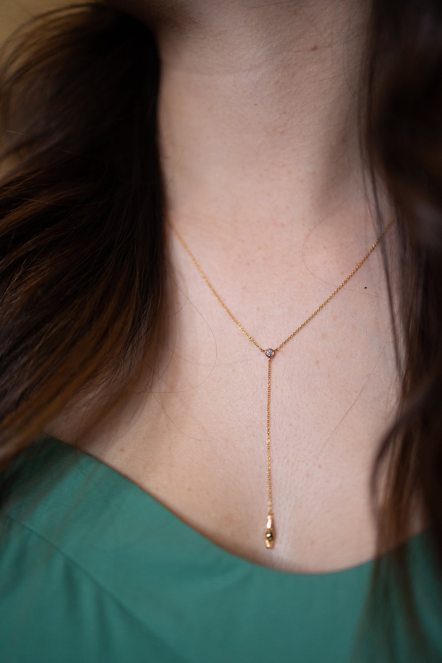 Chouette Designs a close up of the Alsace necklace in gold on a model