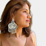 Side profile portrait of a woman wearing the oversized Fyoli Fyoli CLOUD hand-embroidered beaded statement earring.