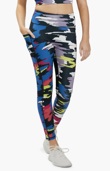 TomboyX Streamline 7/8 Legging Disruptor colorful camo pattern front view on athletic model with pockets