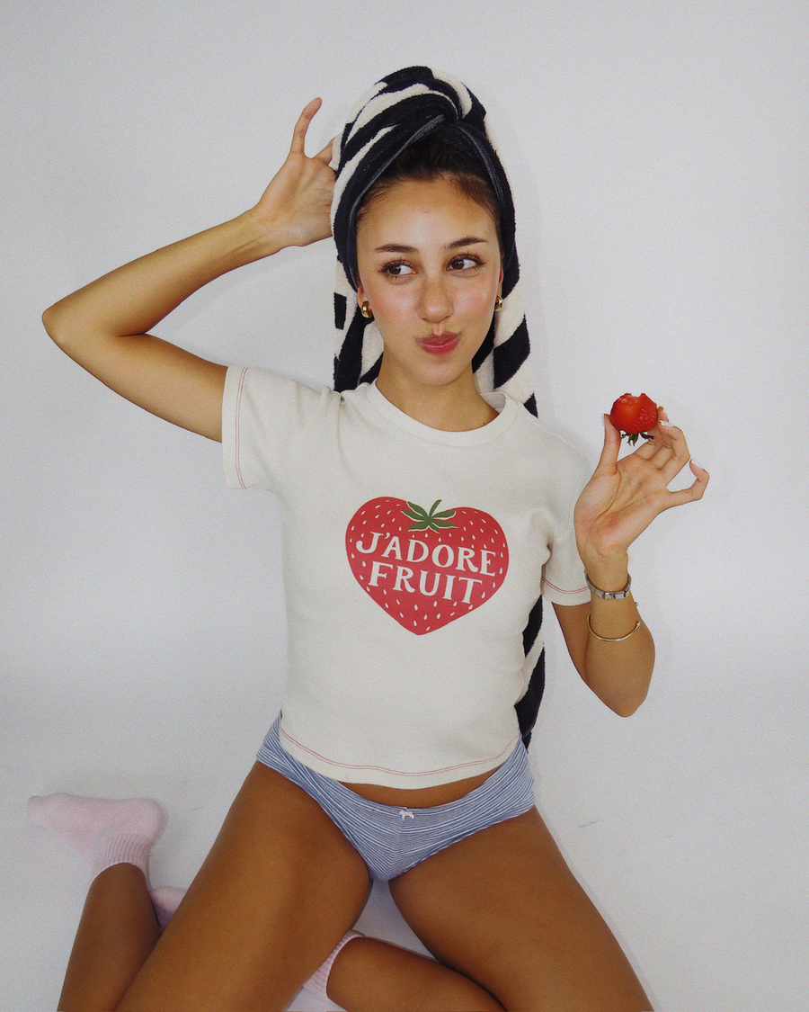Close-up shot of model Dorothy wearing the Fruit Face J'Adore Fruit strawberry graphic baby tee.
