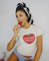 Playful studio pose of model Dorothy in the organic cotton Fruit Face J'Adore Fruit Baby Tee.