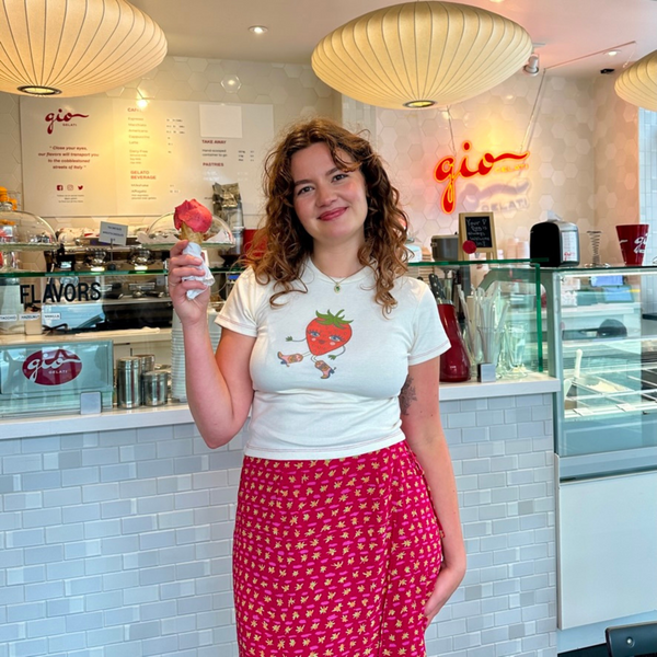 Model wearing Fruit Face Strawberry Cowgirl baby tee with strawberry graphic