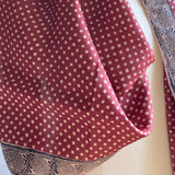 Close-up texture detail of the handwoven Tassar silk fabric, polka dot print, and hand printed double spiral border.