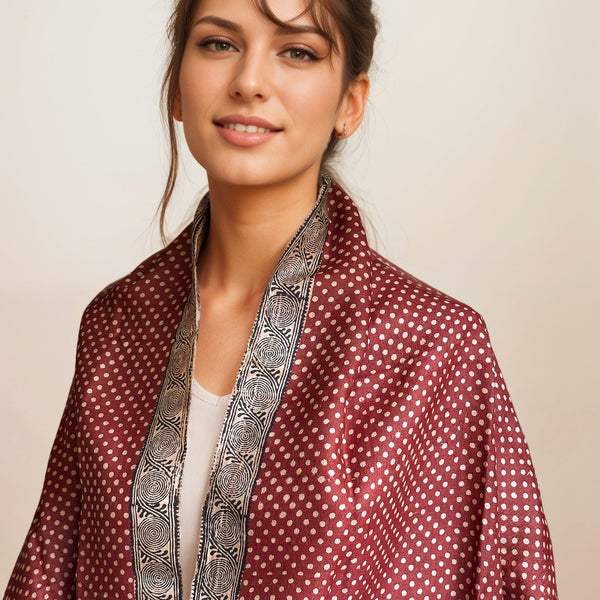 Model draped in the Fyoli Fyoli deep red BINDU Bagh Tassar Silk Stole showing the polka dot pattern and spiral border