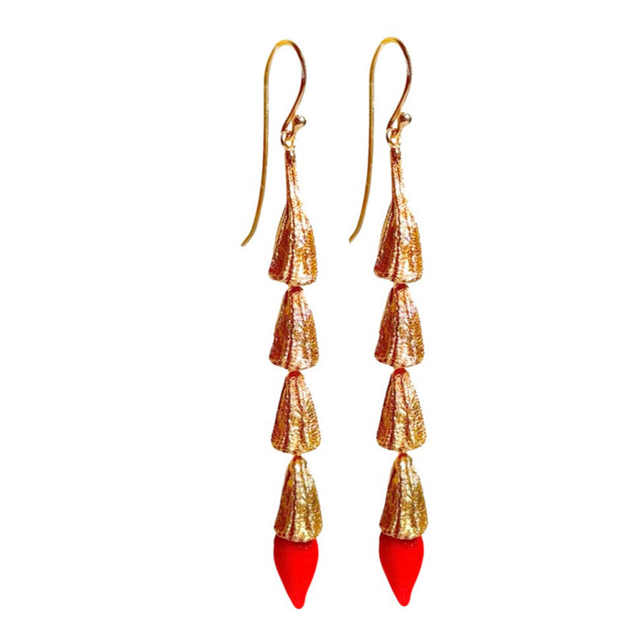 Straight-on view of the pair of gold-plated MIRCHI chili pod dangle earrings with red mouth-blown glass tips.