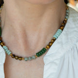 Close-up view of a model wearing the Green Phoebe Gemstone Necklace styled over a white blouse collar.
