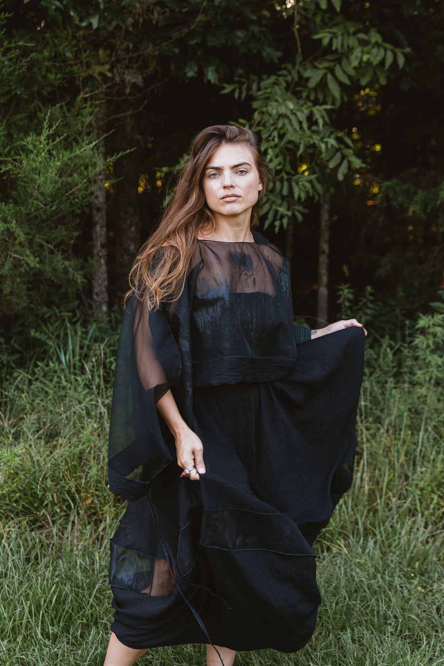 Full-length portrait of a model outdoors in the Hand-Painted Silk & Modal Bellows Skirt paired with matching sheer top.