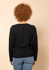 Rear view of a model showing the back fit of the black Hedy Ribbed Modal V-Neck Long Sleeve Tee.