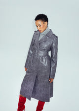 Model Chloe styled in the grey Hilary MacMillan Jodi Trench Coat with a grey turtleneck sweater and red suede boots.