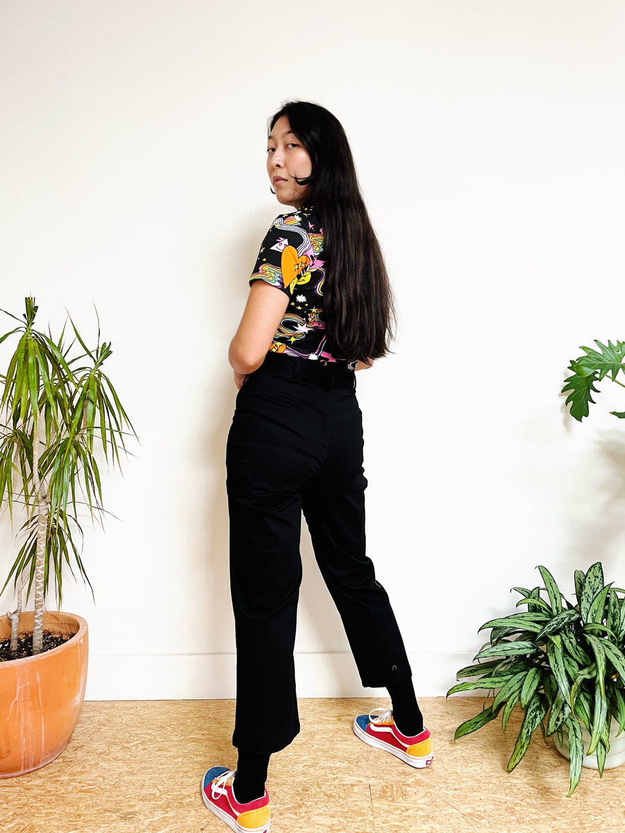 Side and rear view of the black cotton twill carpenter pants showcasing the straight-leg cut and hammer loop detail.