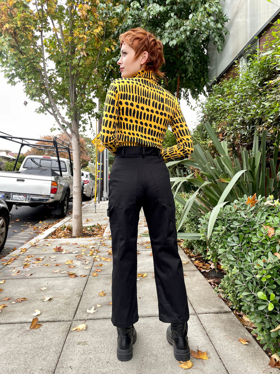 Back view of Nooworks Painter Pants in black twill showing high waist, belt loops, and rear utility pockets.