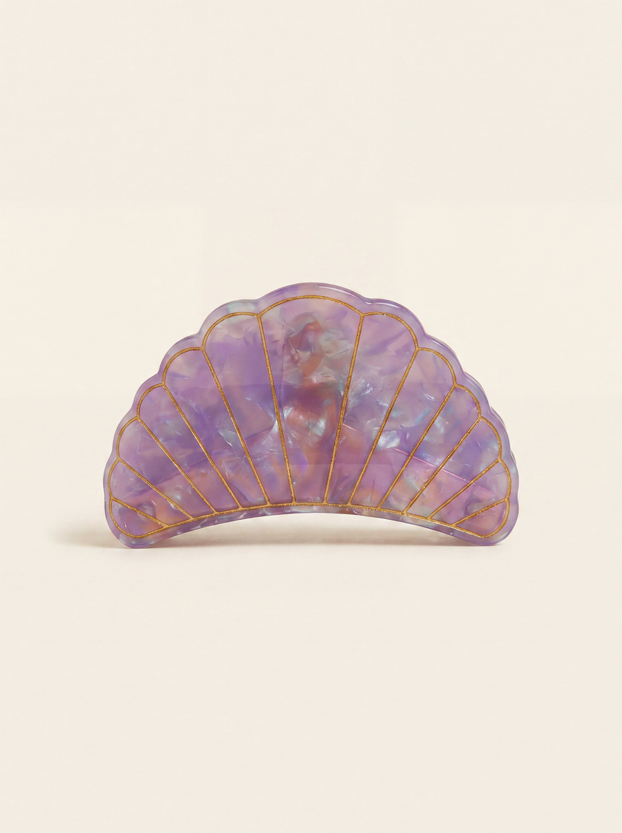 Flat lay view of the Village Thrive Shell Hair Clip in pink and purple marbled recycled acetate, featuring decorative gold-lined shell ridge details.
