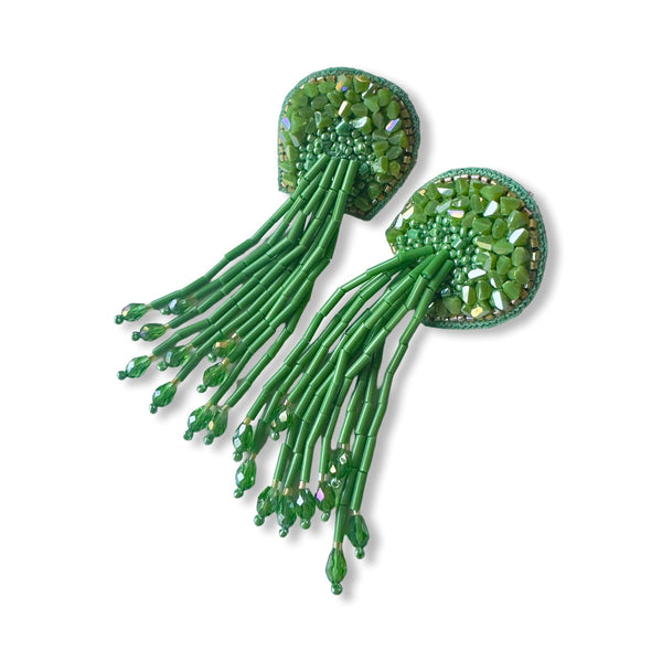 Front view of the green Fyoli Fyoli TORTULA Moss Hand Embroidered Earrings, featuring intricate glass beadwork on a velvet backing with a long, flowing beaded fringe against a white background.