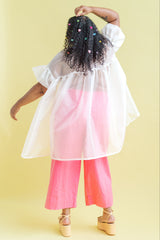 Back view showing the gathered yoke and high-low hem on the white Nettle Studios Silk Organza Mini Mushroom Dress.