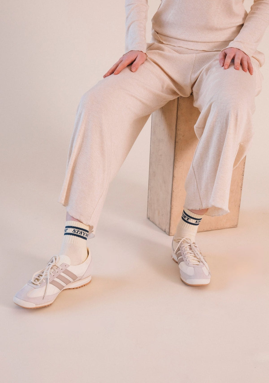 Seated view showing the hemline and cozy drape of the Heather Almond Poplinen Hedy Ribbed Modal Lounge Pant.