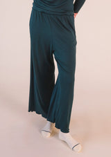 Front cropped view highlighting the wide-leg drape and ribbed modal texture of the Poplinen Hedy Lounge Pant in Pine green