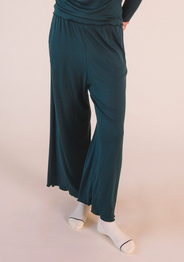Front cropped view highlighting the wide-leg drape and ribbed modal texture of the Poplinen Hedy Lounge Pant in Pine green