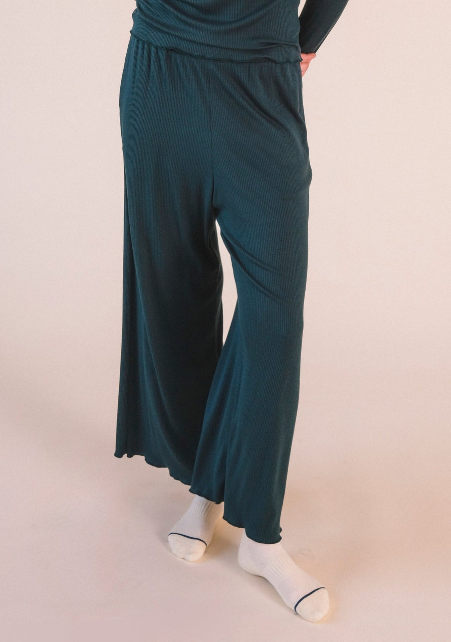 Front cropped view highlighting the wide-leg drape and ribbed modal texture of the Poplinen Hedy Lounge Pant in Pine green