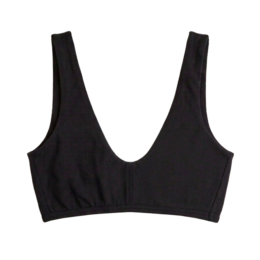 Proclaim Organic Cotton Everyday Bralette in Black, showcasing the wireless deep scoop neckline design . Flat lay product view.