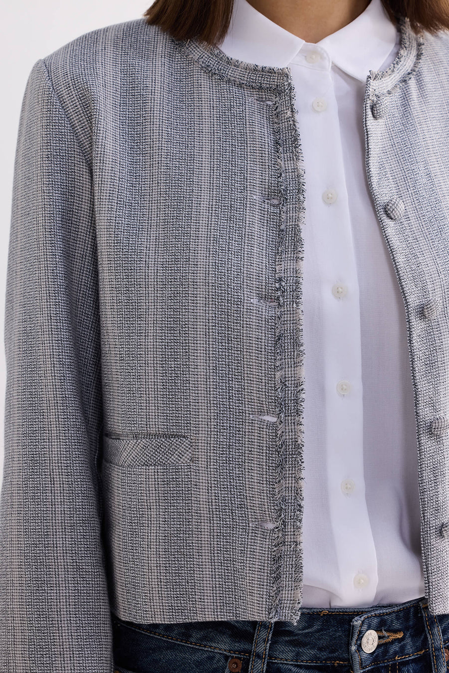 Close-up detail showing the grey cotton tweed texture, front button closures, and collarless neckline of the Reistor Lady Jacket.