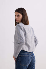 Side profile and back view of model wearing the Reistor Lady Jacket in Grey Cotton Tweed looking over her shoulder.