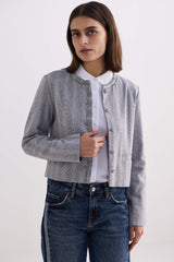 Three-quarter studio pose of model wearing the cropped Reistor Lady Jacket in Grey Cotton Tweed.