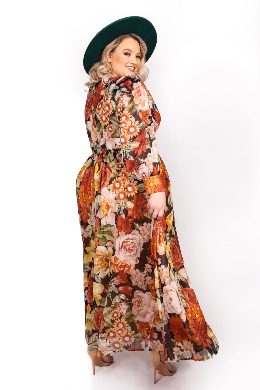 Side profile of model showing the flowing chiffon fabric and sheer long sleeves of the Sante Grace Autumn Queen Maxi Dress.