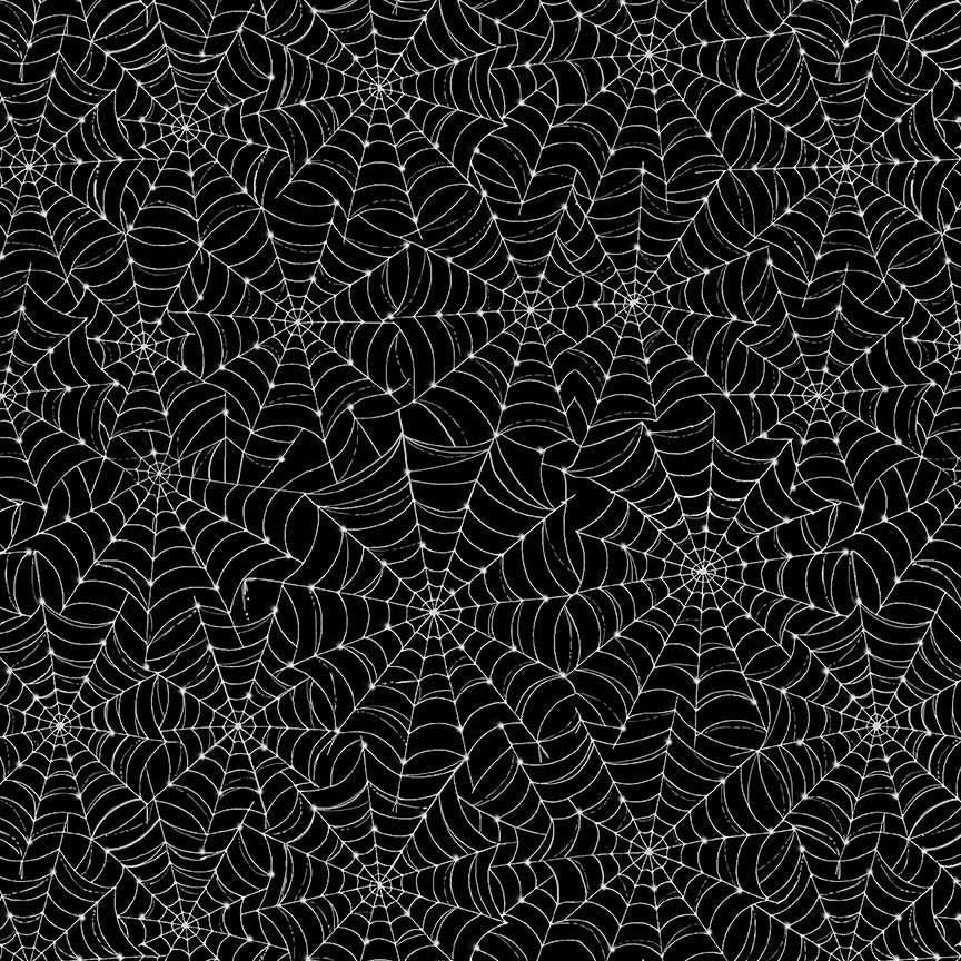 High-resolution print detail of the white spiderweb graphic pattern on a black fabric background.