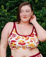 Close-up front view of model Jennice wearing the Thunderpants USA Longline Bra in size XL mushroom print.